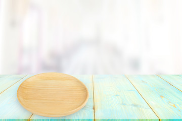 Wooden plate on table wooden board empty table in front of blurred background,can be used for display or montage your products. Mock up for display of product.