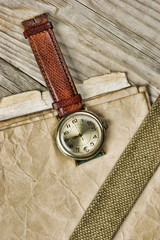 vintage paper and old broken watch on wooden boards