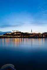 Bratislava, New Bridge, Castle, Cathedral during dusk from a boat on river Danube