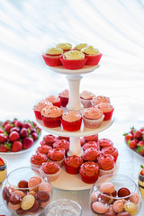 Sweet table . Desserts, caps, macaroni, marshmallows, strawberries