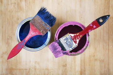 Full of blue paint tines and paint brushes on it