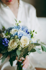 Bride holding big wedding bouquet on wedding ceremony