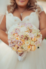 Bride holding big wedding bouquet on wedding ceremony