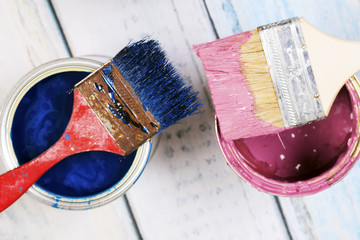 Full of blue paint tines and paint brushes on it