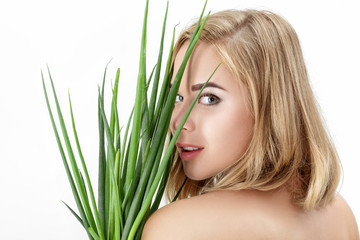 Naklejka premium Portrait of Beautiful blond woman holding green onion on white background. Health and vitamins