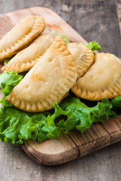 Typical Spanish empanadas on wooden table
