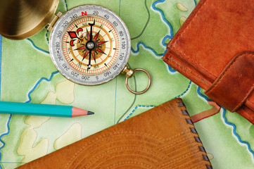 compass wallet and passport on the old map