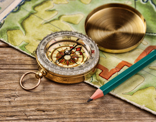 old map and compass on a wooden table