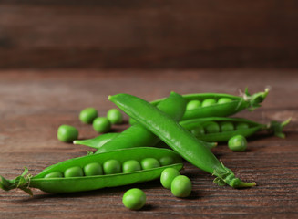 Fresh green peas on wooden background