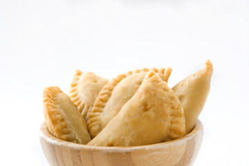 Typical Spanish empanadas in bowl isolated on white background

