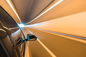 car driving fast exit the tunnel