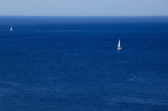 Yacht with white sales in the blue sea