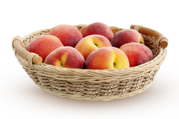 Basket with peaches on a white background.