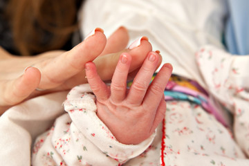 Mom's hand and the hand of a baby