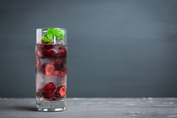 Cherries mojito on the wooden background. Selective focus.