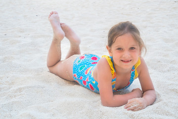 Cute girl playing on the sand