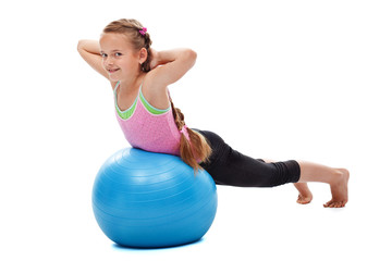 Young girl doing back strengthening gymnastic exercises