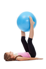 Fototapeta na wymiar Young girl doing legs and abdomen gymnastic exercises