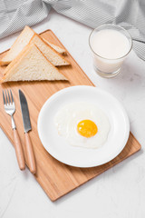 Top view of traditional healthy easy quick breakfast meal made of fried eggs served on a plate.