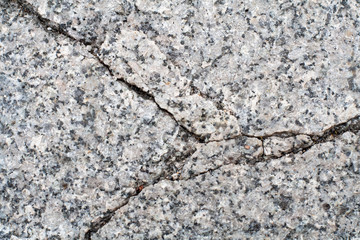 cracked gray granite stone. background, texture