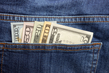 American dollar bills in jeans pocket background