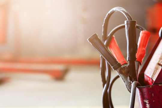closeup battery charger in car repair center with soft-focus and over light in the background