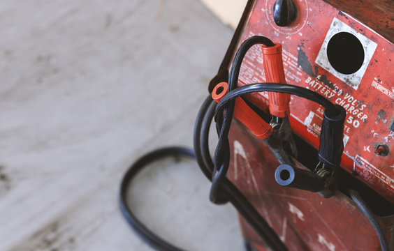 closeup battery charger in car repair center with soft-focus and over light in the background