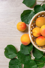 Fresh apricots in the basket On a wooden table