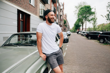 Hipster  model with beard  wearing white blank  t-shirt with space for your logo or design in...