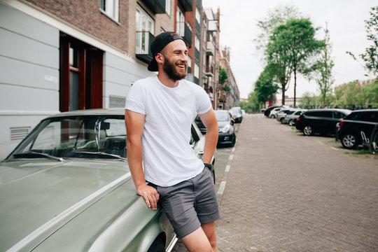Hipster  model with beard  wearing white blank  t-shirt with space for your logo or design in casual urban style