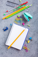 Background with assorted colorful school supplies on gray stone table. Concept with copy space.