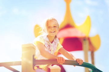 Obraz na płótnie Canvas happy little girl climbing on children playground