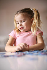 Girl playing puzzle.