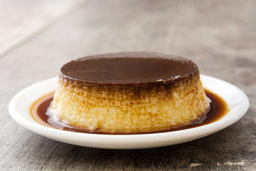 Creme caramel. Egg pudding on wooden table
