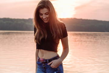 Summer spring portrait of young beautiful woman smile in the park sunset