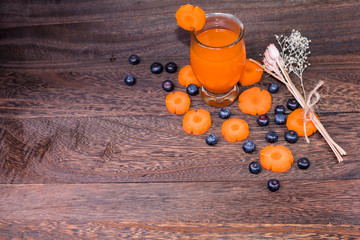 Healthy eating and dieting concept,fresh carrot  and carrot juice or organic healthy juice in glass ,fruit,vegetables on a grey wooden table wall background