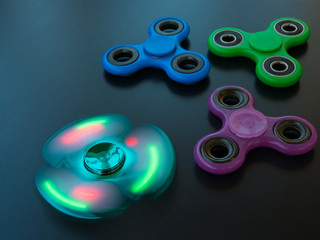 Popular colourful fidget spinner toy on a black background