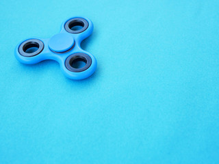 Popular colourful fidget spinner toy on a colored background