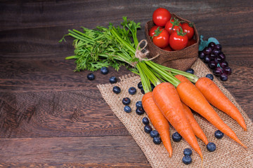 Healthy eating and dieting concept,fresh carrot  or organic healthy , tomato ,fruit,vegetables on a grey wooden table wall background