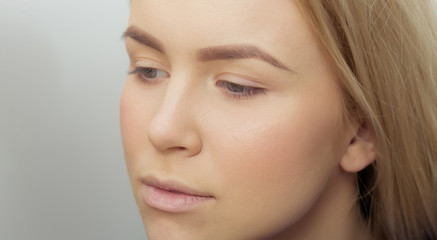 Naklejka premium Girl with makeup foundation on adorable face