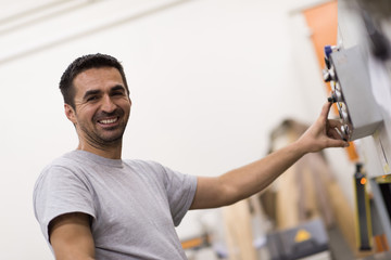 worker in a factory of wooden furniture