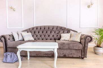 White apartment interior design living room with classic furniture, sofa and white table, flower and tv audio set, modern style in chisinau, cenral district, moldova