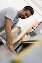 worker in a factory of wooden furniture