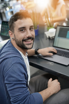 Man in coworking office working on laptop