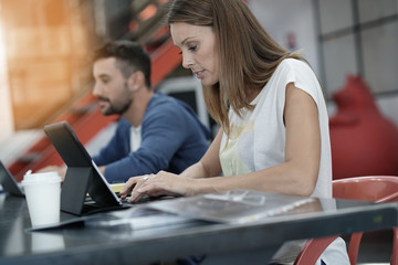 Trendy young people working in co-working office