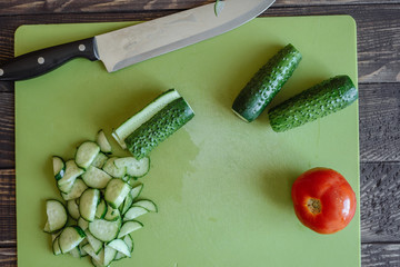 Woman cutting cucumber