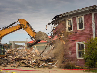 demolition of an old house with power shovel
