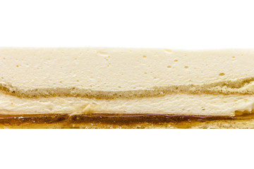 Orange mousse cake texture on white background. Orange biscuit, orange mousse, cream, orange jelly