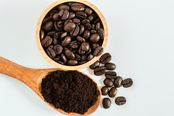Roasted coffee beans and Crushed Coffee Powder with a white background