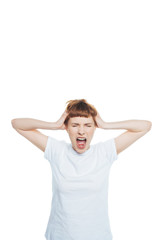 Stressed young woman with headache holding hands on head and screaming with closed eyes isolated on white